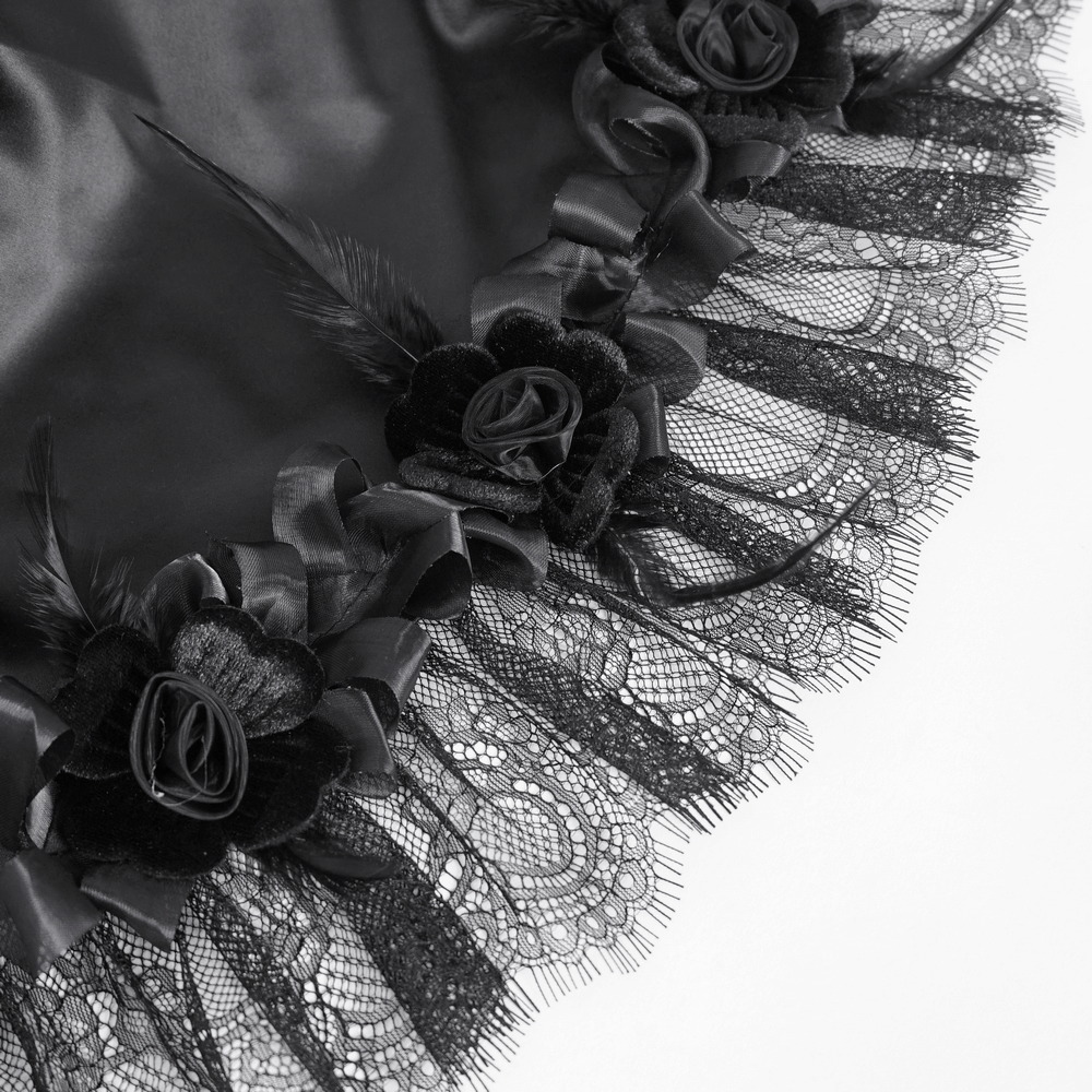 Close-up of intricate black lace trim with floral embellishments and satin lining for a gothic maxi skirt.
