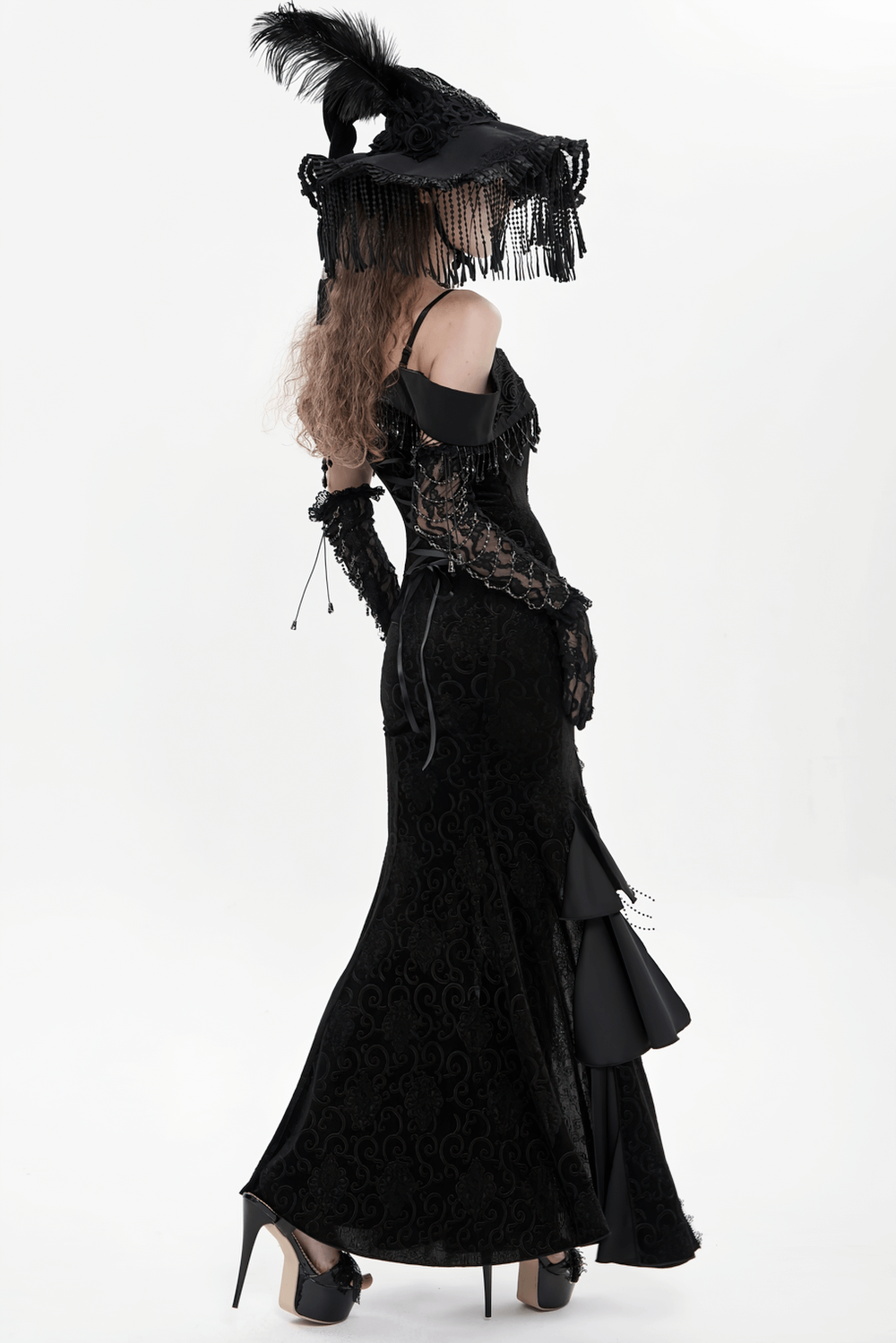 Gothic Black Lace Off-Shoulder Dress with Ruffles and Beads worn by a model with a dramatic hat and elegant style.