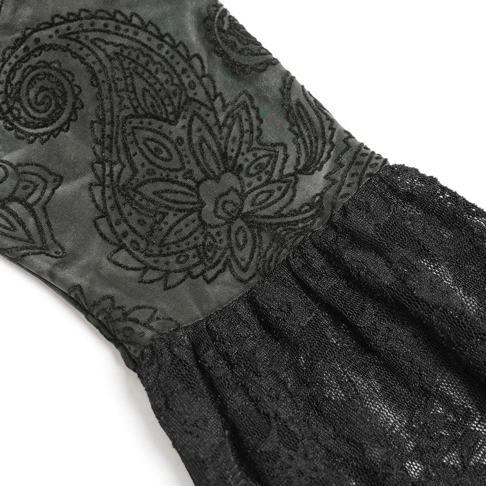 Close-up of black lace and patterned fabric, showcasing gothic elegance and intricate details.