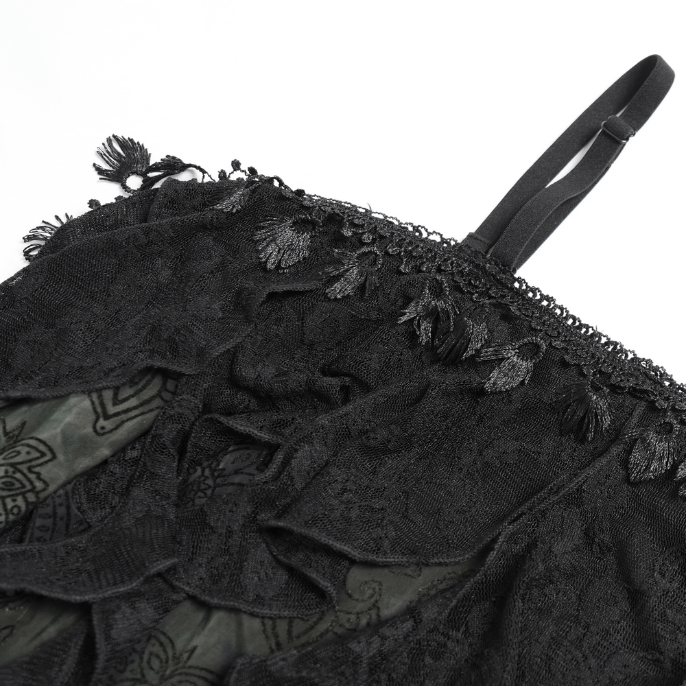 Close-up of black lace detail on gothic off-shoulder top, featuring floral accents and adjustable straps.