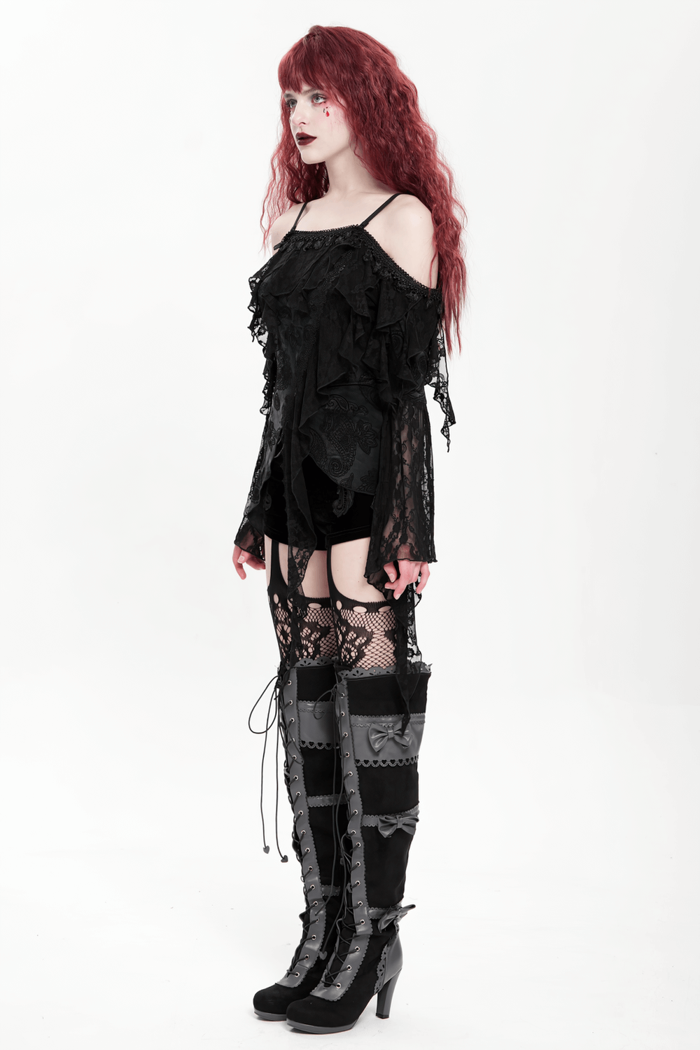 Gothic black lace off-shoulder top with flared sleeves and ruffles, paired with thigh-high lace-up boots.