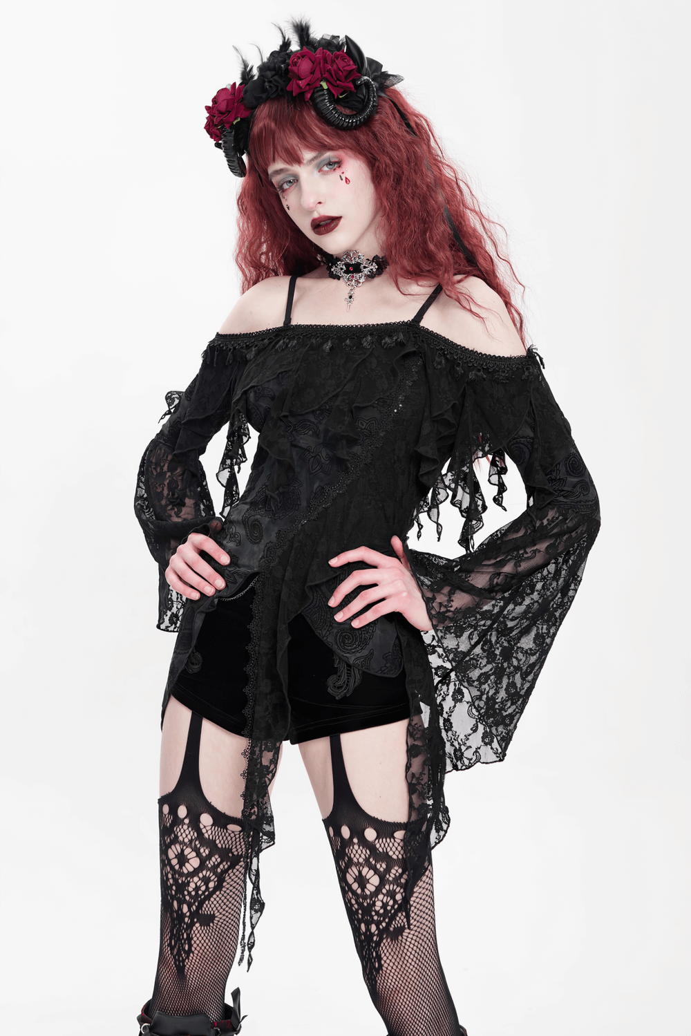 Gothic black lace off-shoulder top with flared sleeves styled with a floral crown and intricate tights.