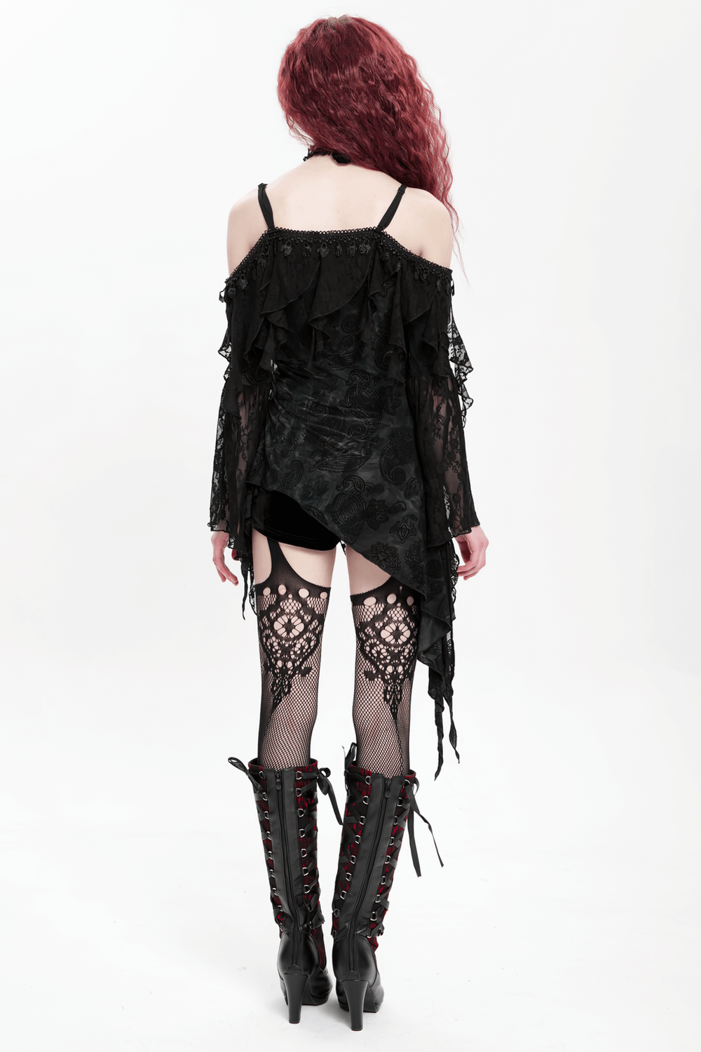 Romantic gothic black lace off-shoulder top with flared sleeves, worn with edgy knee-high boots.