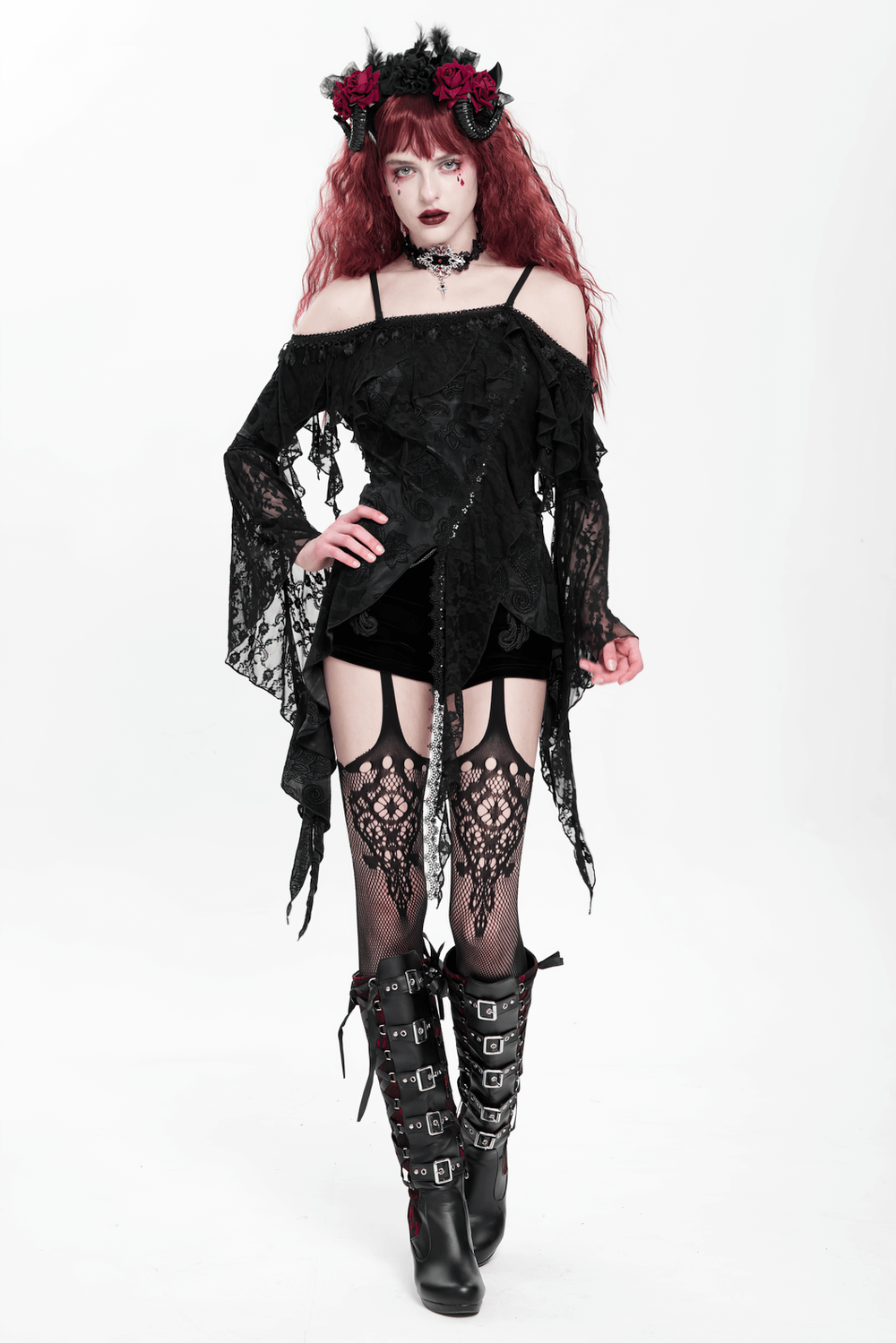 Gothic black lace off-shoulder top with flared sleeves, paired with lace stockings and bold black boots.