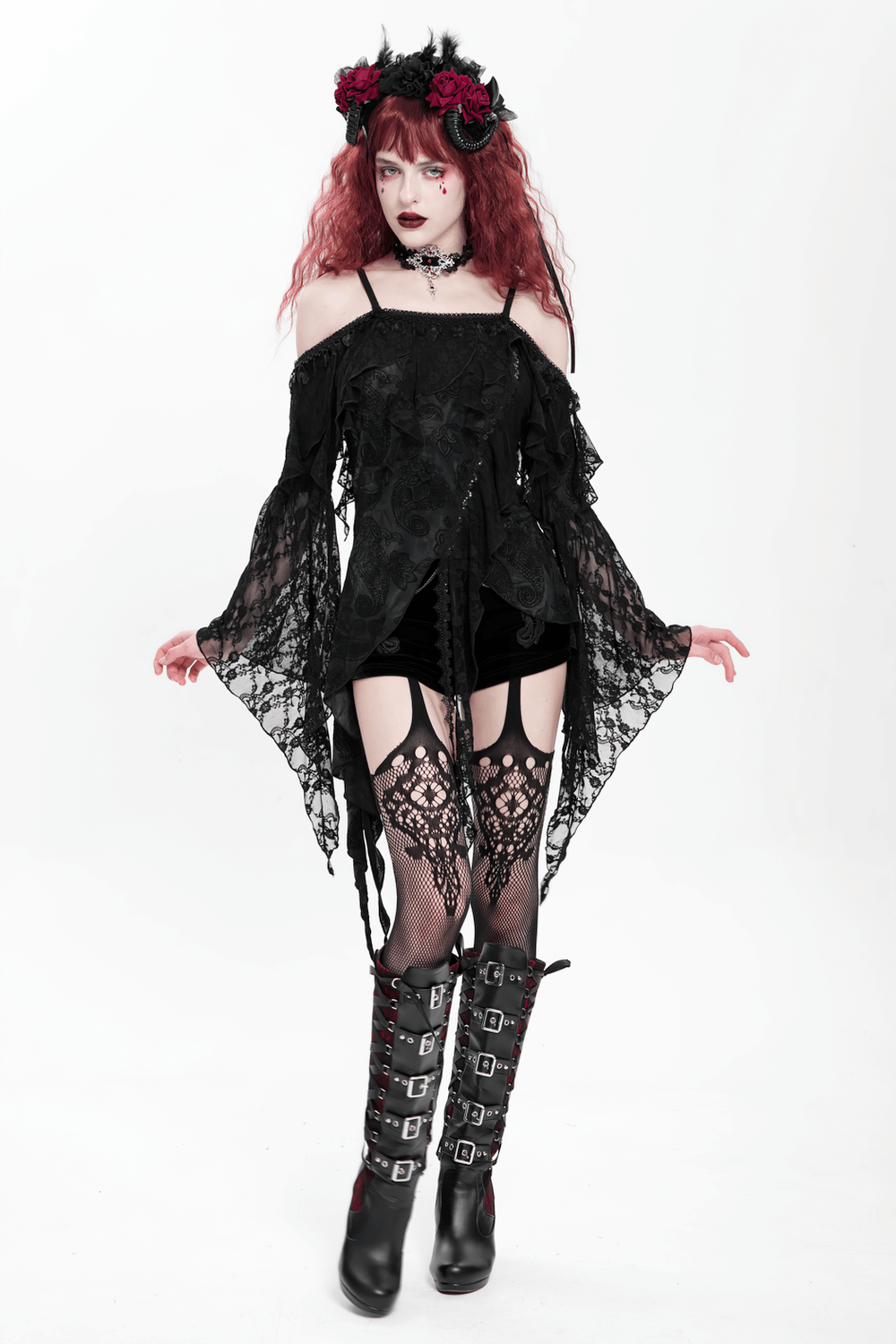 Gothic black lace off-shoulder top with flared sleeves, styled with layered ruffles and dramatic hem, paired with stylish accessories.
