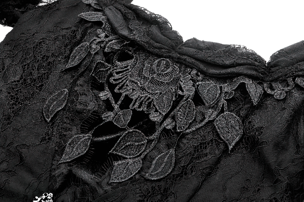 Close-up of intricate black lace detailing on a gothic long maxi dress, showcasing floral patterns and Victorian elegance.