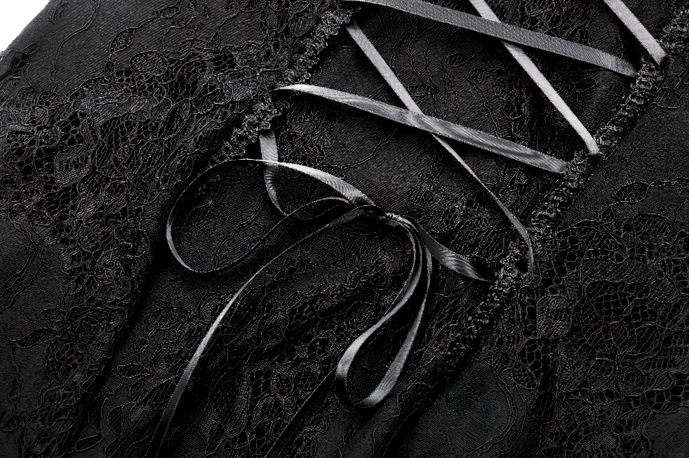Close-up of the gothic black lace corset back details with satin ribbons on a stylish maxi dress.