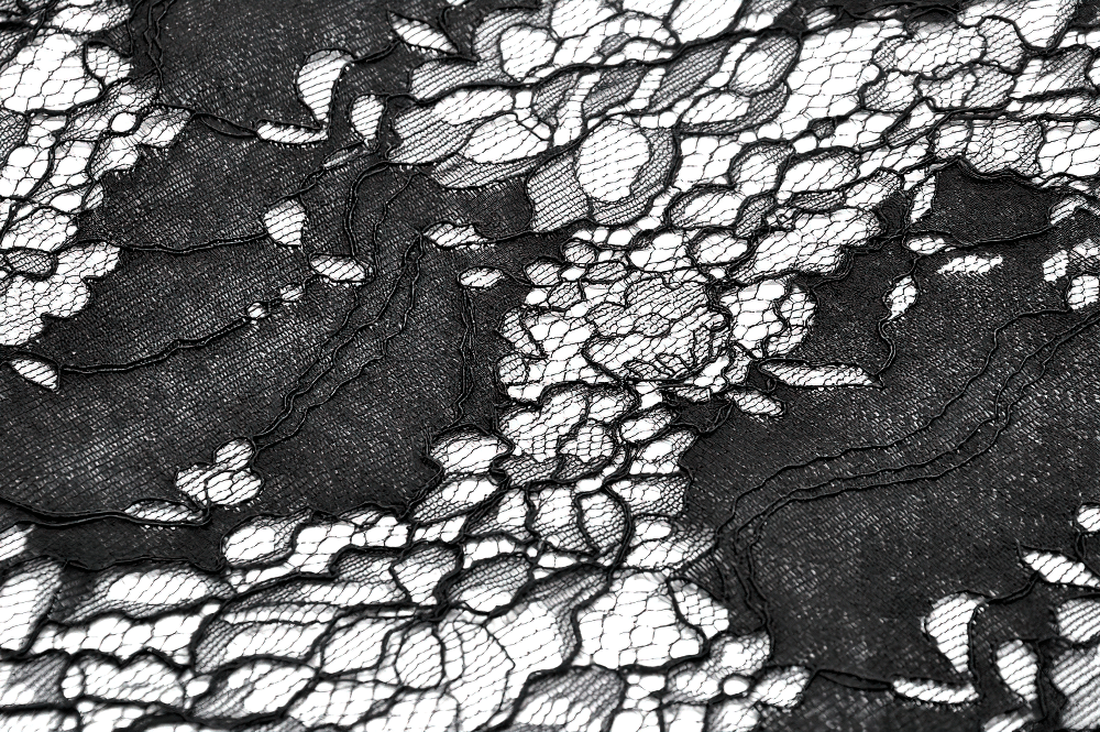Close-up of intricate black lace with floral patterns, perfect for gothic fashion and elegant garments.