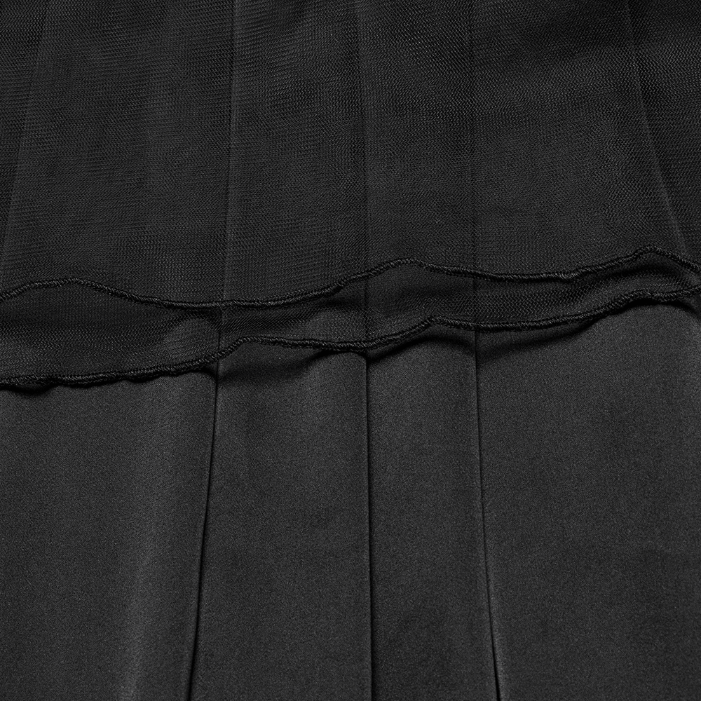 Close-up of elegant black pleated fabric, showcasing the sleek texture perfect for a gothic maxi dress.