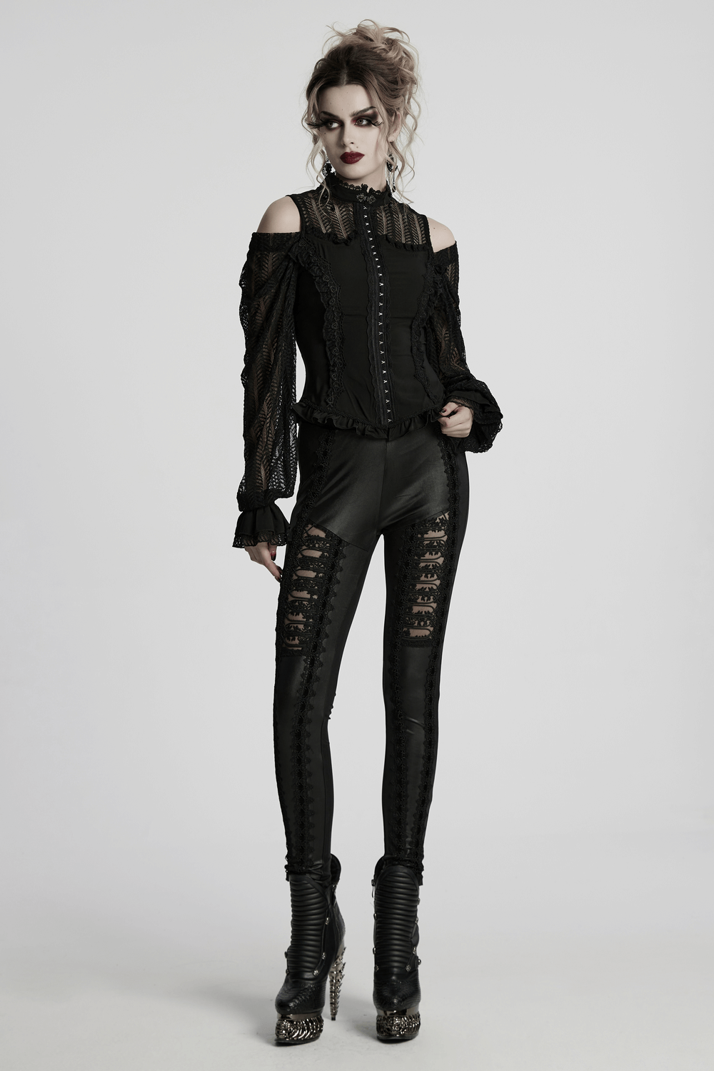 Gothic black lace swing sleeve shirt with rose details, styled with edgy black leggings and bold high-heeled boots.