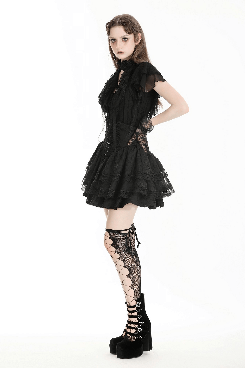 Gothic black lace trim blouse with ruffled sleeves and stylish lace stockings in a dark fashion look.