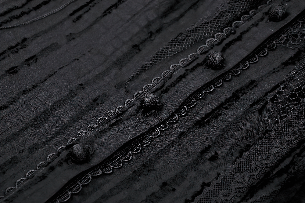 Close-up of Gothic black blouse fabric with lace trim and textured patterns, showcasing intricate detailing.