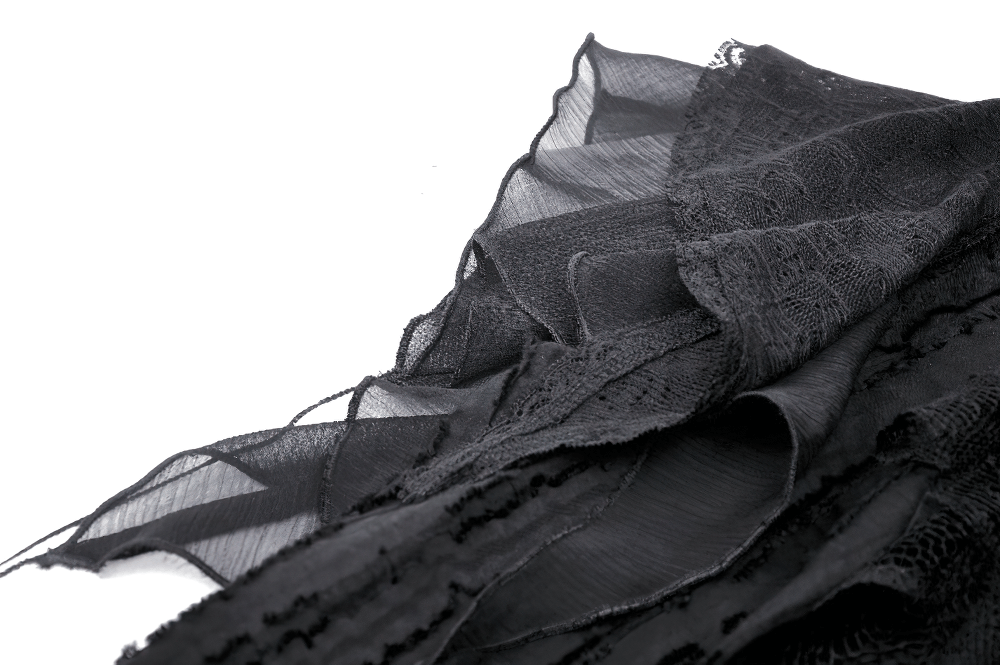 Black lace fabric with intricate detailing and ruffled edges, perfect for gothic and Victorian-inspired fashion.