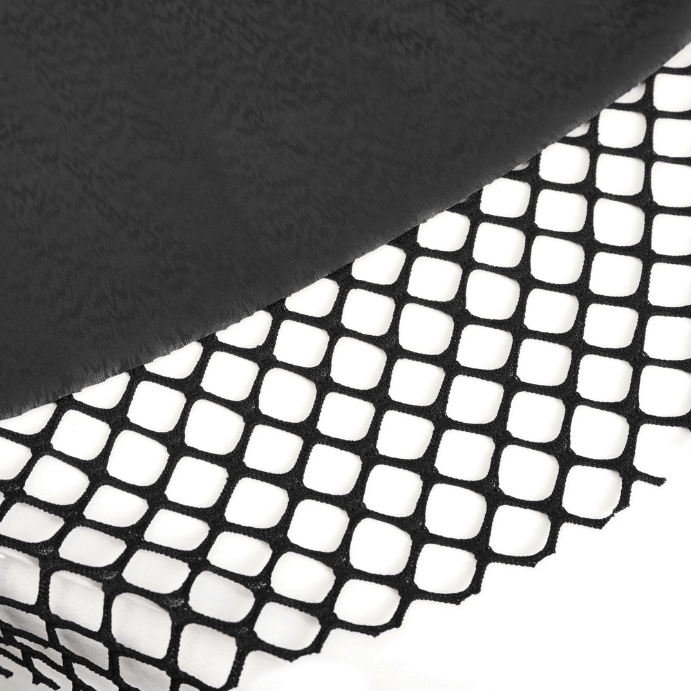 Close-up of black lace fabric and fishnet detailing for a gothic corset dress, showcasing alternative fashion elements.