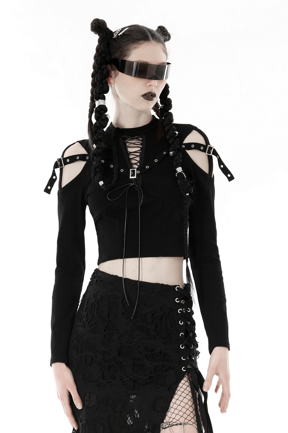 Gothic black lace-up crop top with cut-out shoulders and strappy details, styled with edgy accessories.