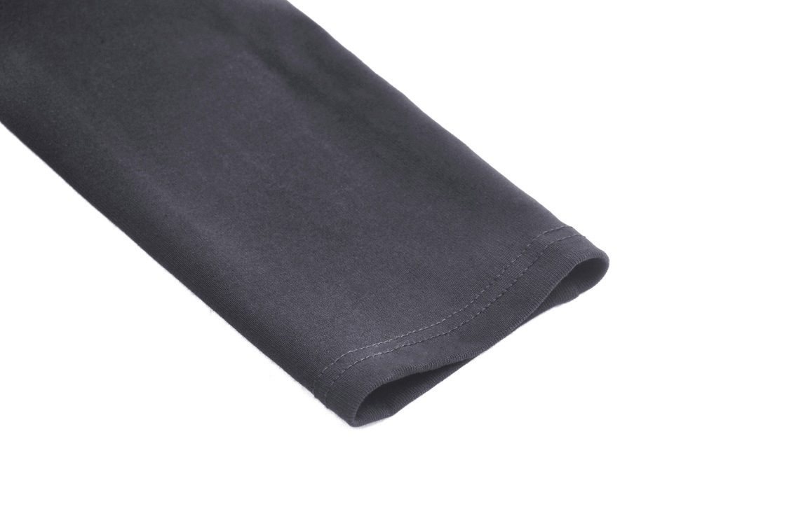 Close-up of a black sleeve detail showcasing premium fabric and stitching for a gothic-inspired crop top.