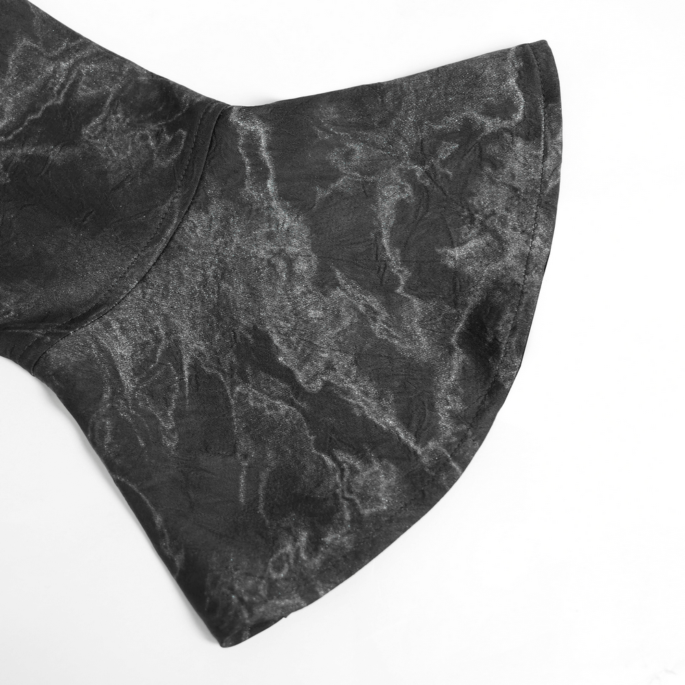 Close-up of flared cuff on gothic black lace-up shirt, showcasing dark marble texture and unique design.