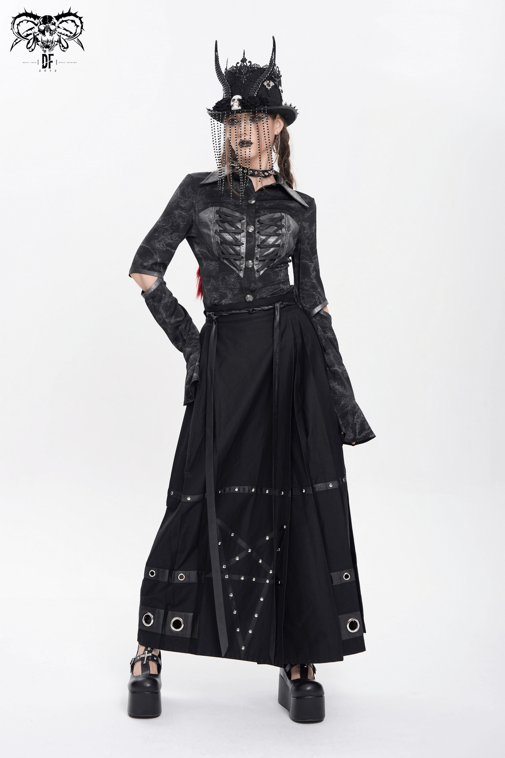 Gothic black lace-up shirt with cut-out sleeves, paired with a dramatic long skirt and a stylish hat.