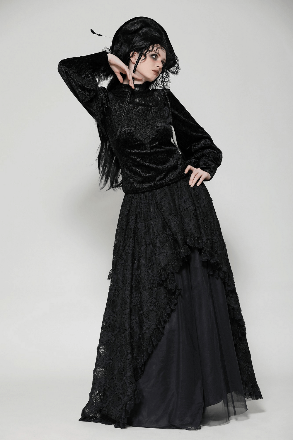 Elegant gothic black lace Victorian top with high neck and voluminous sleeves, paired with matching flowing skirt in dramatic pose.