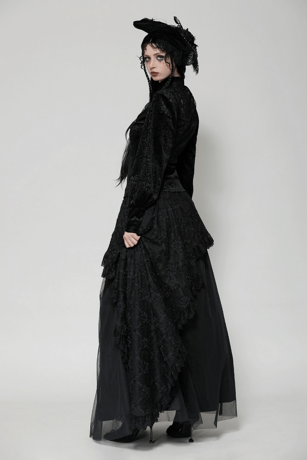 Gothic black lace Victorian top paired with a dramatic skirt, showcasing intricate velvet design and high-neck elegance.