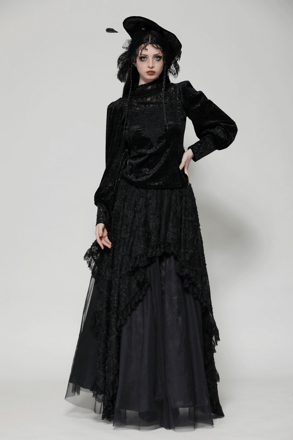 Gothic black lace Victorian top with high neck and dramatic sleeves, paired with a flowing skirt and elegant hat.