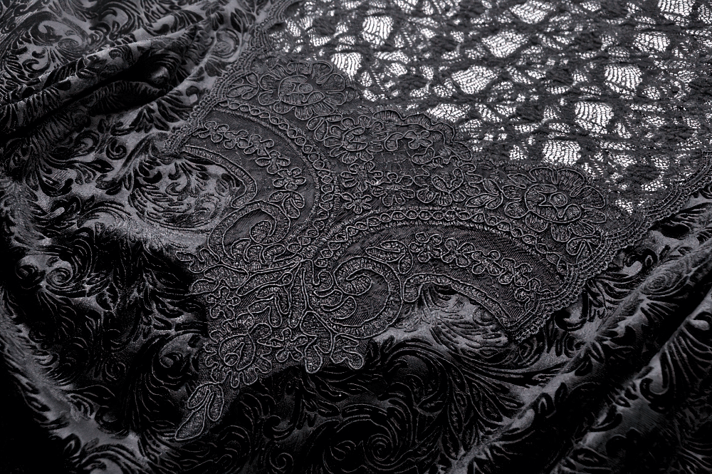 Close-up of intricate black lace and velvet fabric, showcasing Victorian-inspired floral designs and gothic elegance.