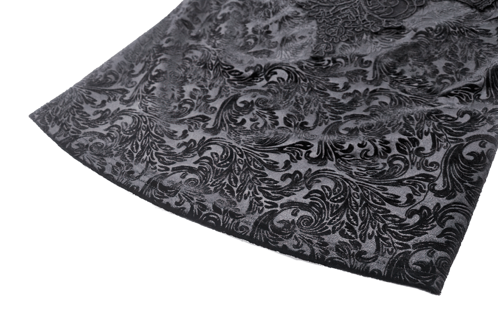 Close-up of intricate black velvet fabric with floral damask design, perfect for gothic fashion enthusiasts.