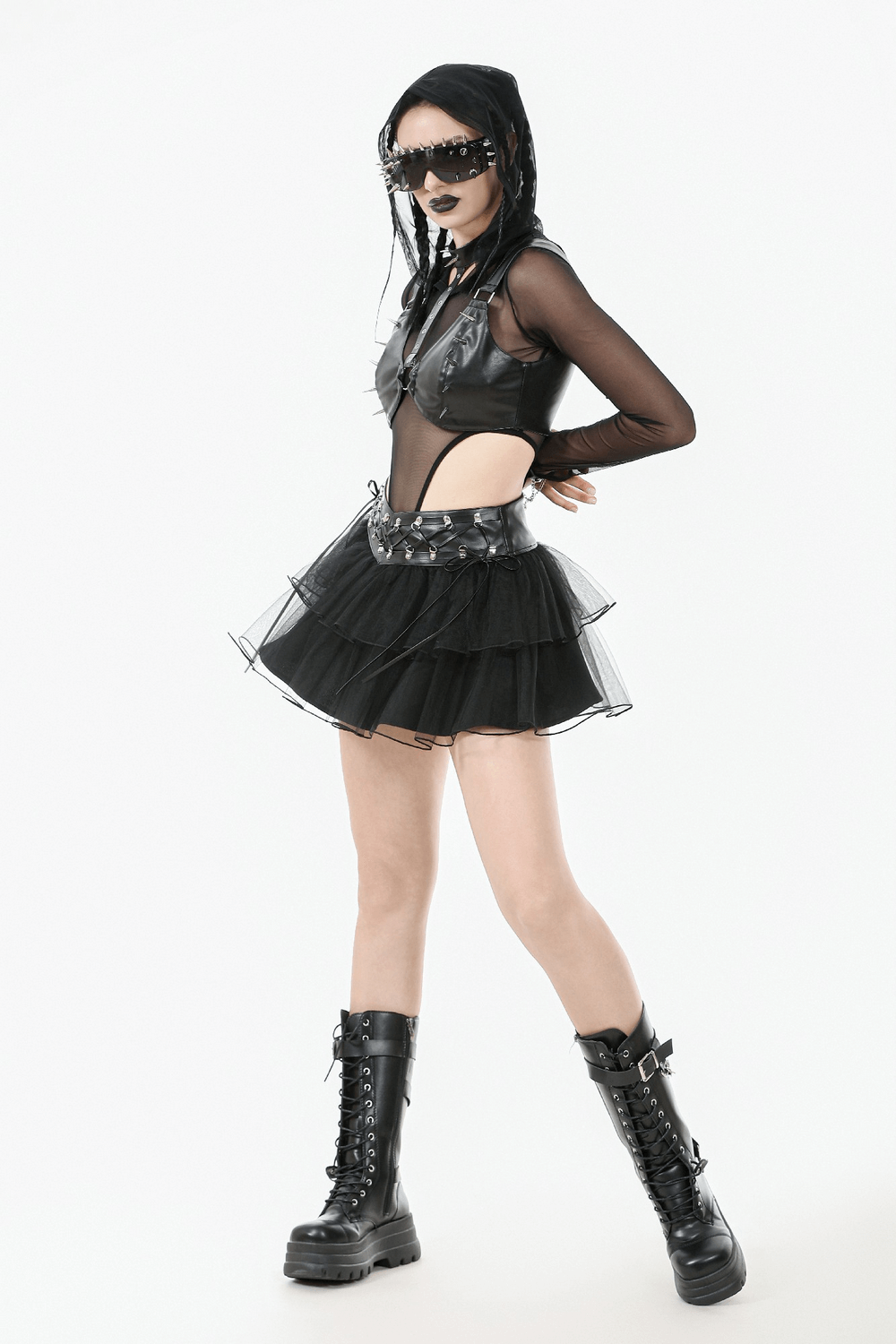 Gothic black layered tulle mini skirt with harness detail, paired with edgy accessories and bold black combat boots.