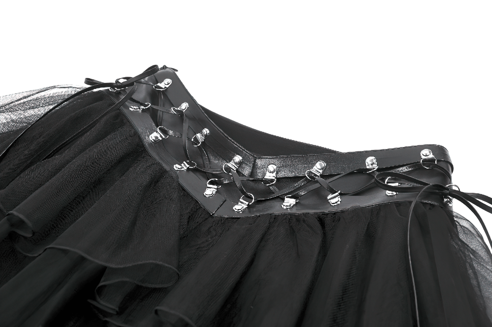 Close-up of gothic black layered tulle mini skirt with harness detail and faux leather waistband.