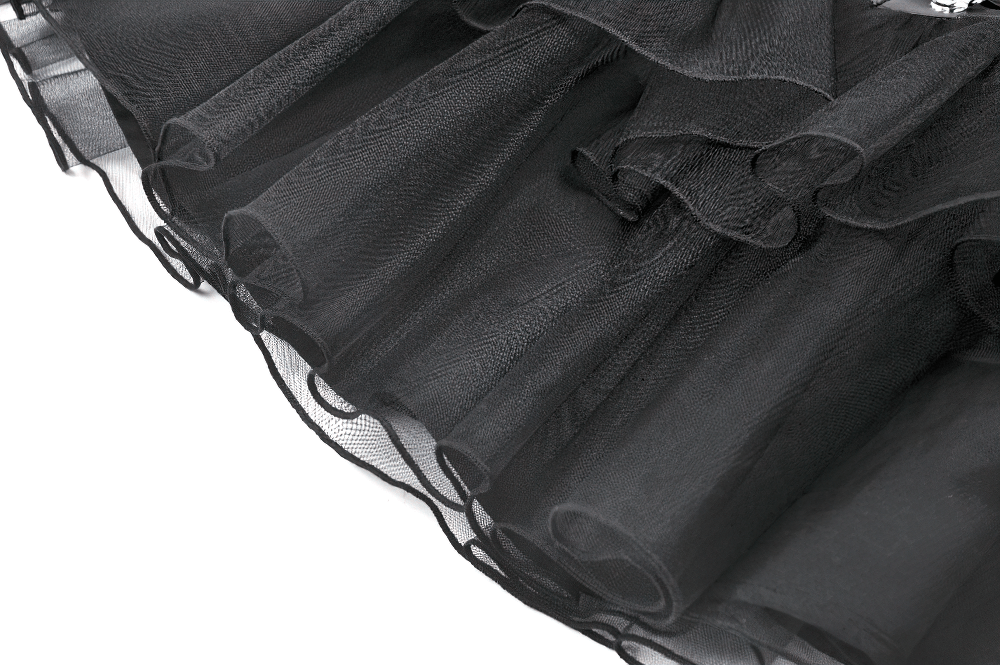 Close-up of gothic black layered tulle fabric showcasing ruffled edges and sheer texture, perfect for alternative fashion.