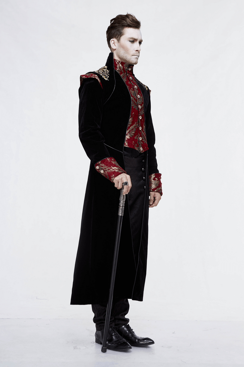 Stylish man in a vintage gothic long black coat with red accents, holding a cane, showcasing a retro look.