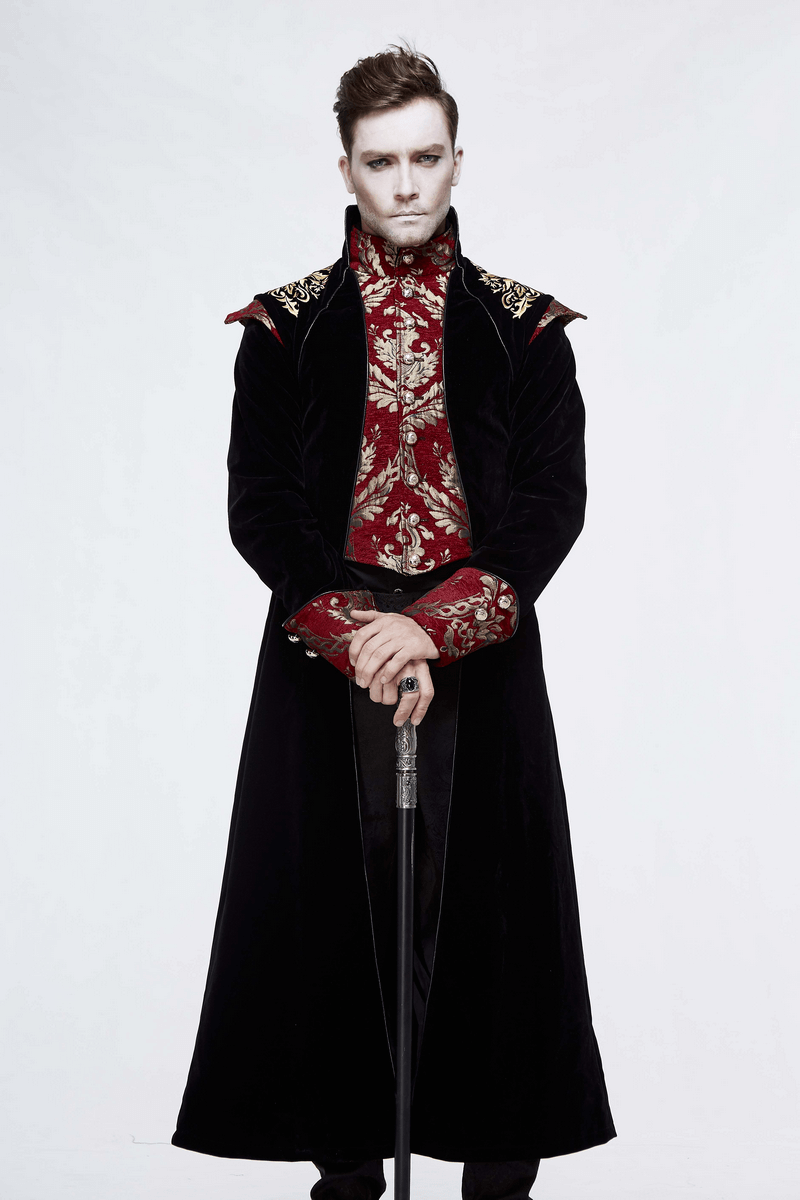 Stylish man in a vintage gothic black long tail coat with red floral pattern, holding a cane, showcasing elegance.