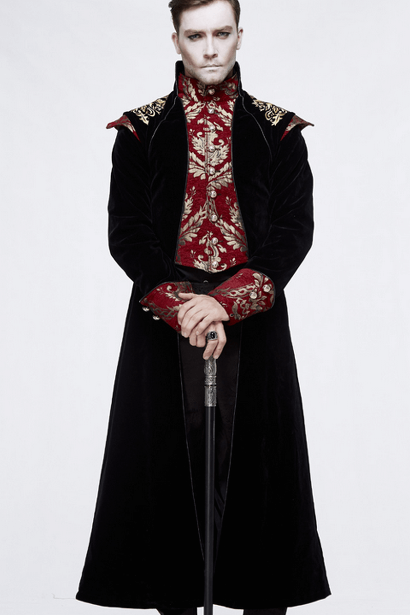 Stylish man in a gothic black long tail coat with vintage gold patterns and a red floral shirt, posing confidently.