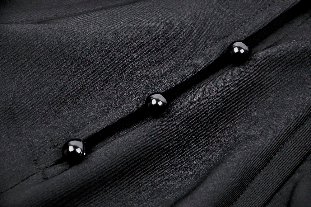 Close-up of black buttons on a gothic hooded cape, highlighting sleek fabric and structured design details.