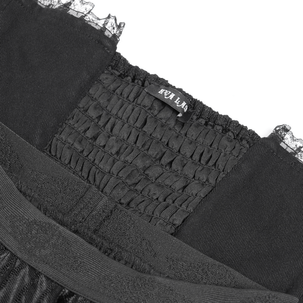 Close-up of the gothic black maxi skirt showing corset waist detail with lace trim and stretchy smocked fabric.