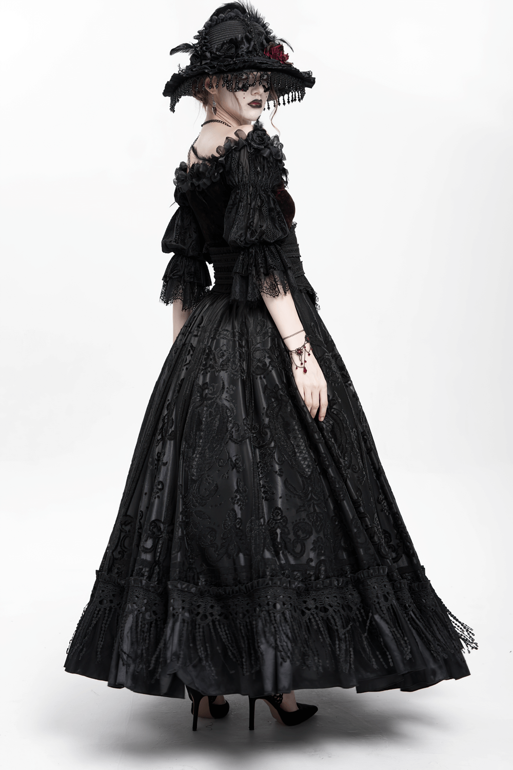 Gothic Victorian black dress with lace details and wide-brimmed hat, showcasing an elegant silhouette from the back.