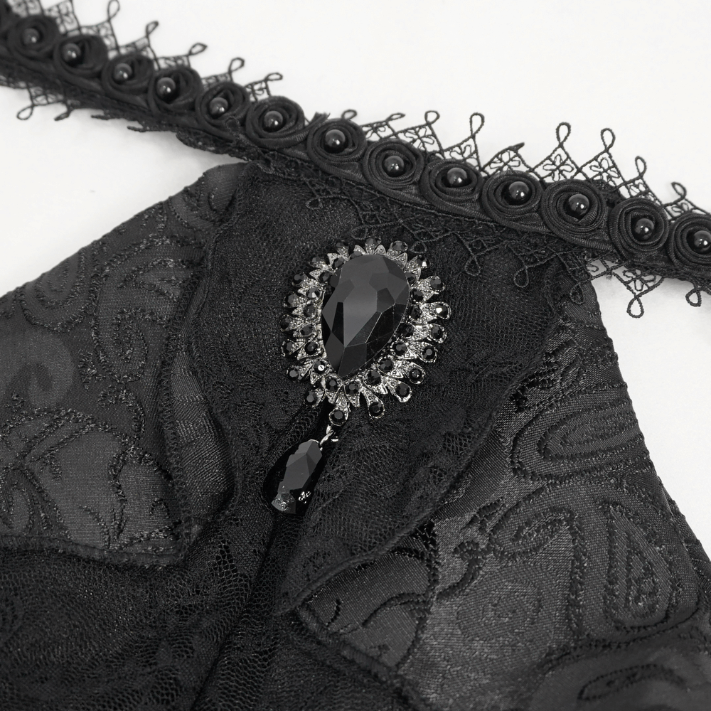 Close-up of gothic black shirt collar with lace and jewel detail, adding vintage elegance and steampunk style.
