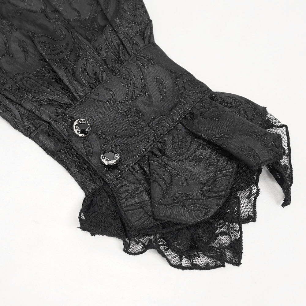 Close-up of Gothic black men's shirt cuff with paisley pattern and buttons, showcasing vintage steampunk style.