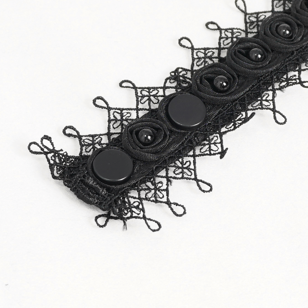 Close-up of a black lace trim with decorative buttons, perfect for Gothic or steampunk fashion embellishments.