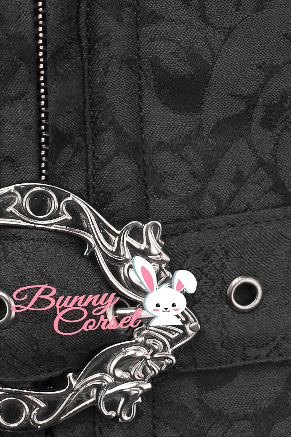 Close-up of a gothic black corset metal busk closure with intricate brocade details and Bunny Corset logo.