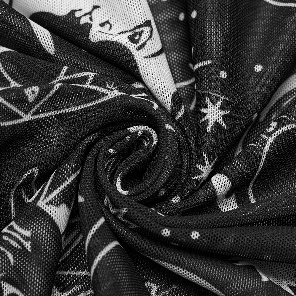 Close-up of black mesh fabric featuring celestial sun and moon print for gothic fashion.