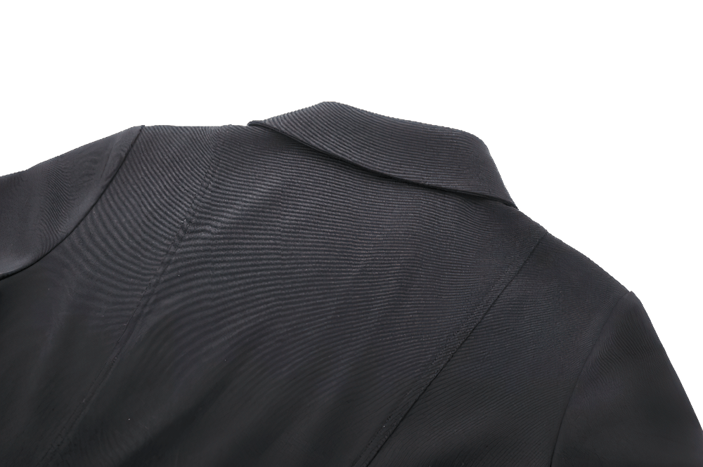 Close-up of the back collar detail of a black dress, highlighting its sleek design and textured fabric.