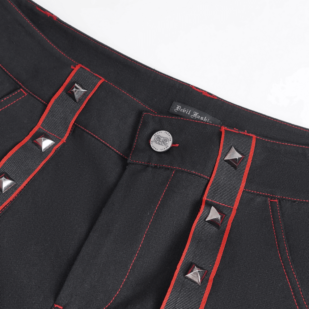 Gothic black pants showcasing striking red stitching and metal accents for an edgy fashion statement.