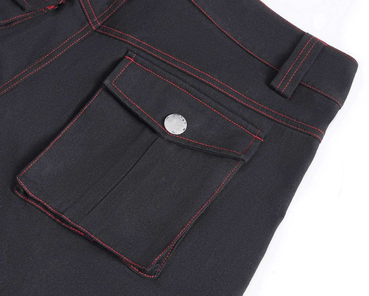 Close-up of gothic black pants with red stitching and metal accents pocket, showcasing edgy style and functional design.