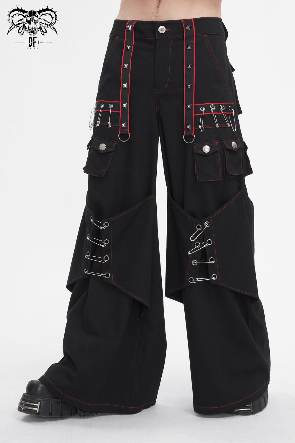 Gothic black pants with red stitching and metal accents, featuring pockets and edgy style for the fashion-forward individual.