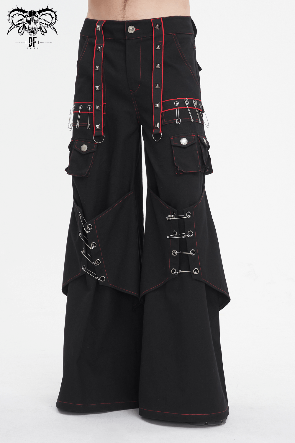 Gothic black pants with red stitching and metal accents, featuring loose pockets and edgy style, perfect for fashion-forward individuals.