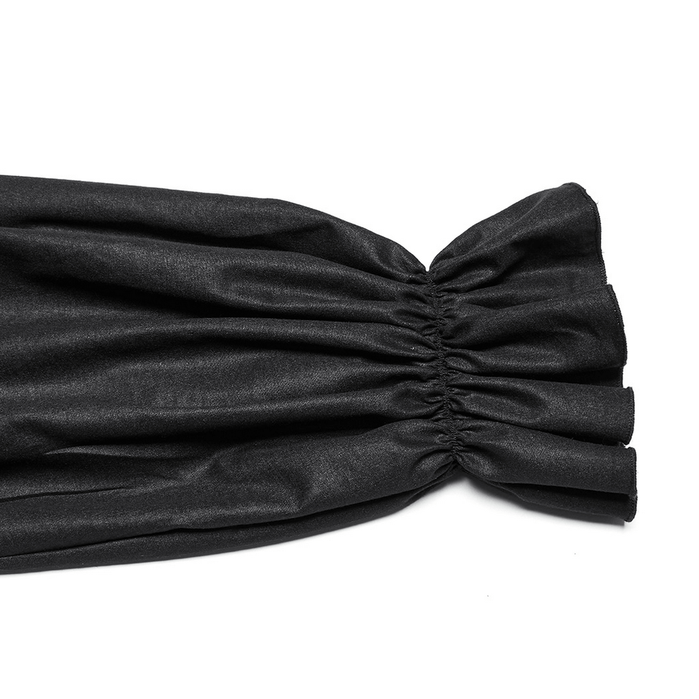 Close-up of ruffled cuffs on a Gothic black pleated shirt, showcasing textured fabric and elegant detailing.