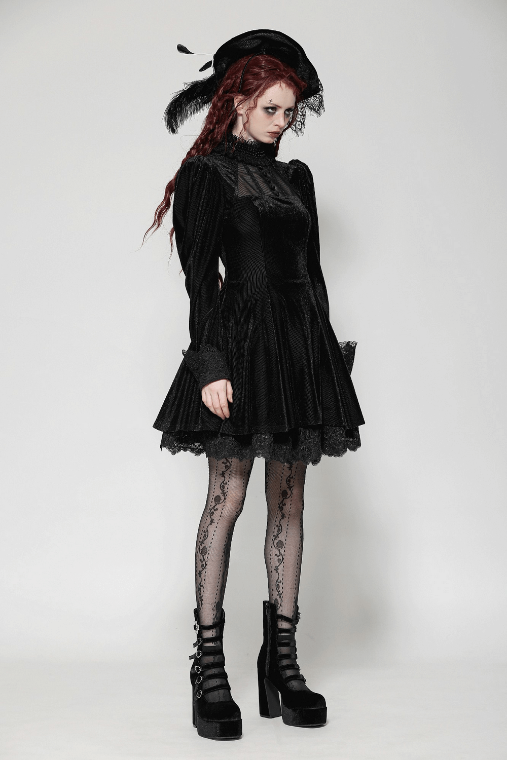 Gothic black ruffled velvet dress with lace and puff sleeves, styled with platform heels and intricate tights.