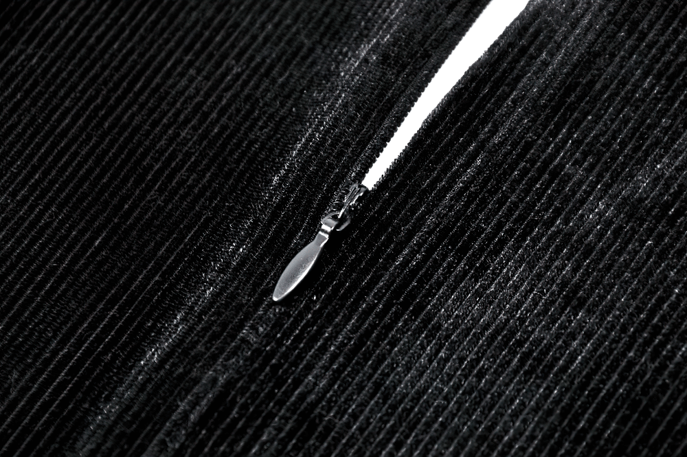 Close-up of black velvet dress zipper highlighting elegant design and sleek detail.