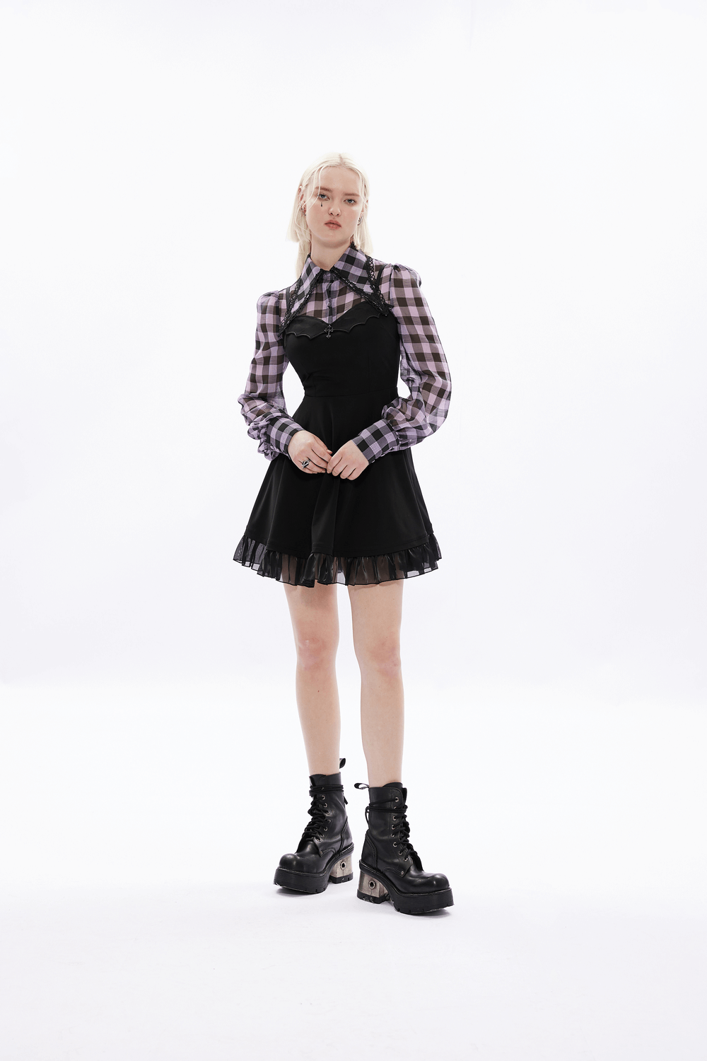 Gothic black scalloped skater dress with lace hem, paired with a plaid shirt and stylish black boots.